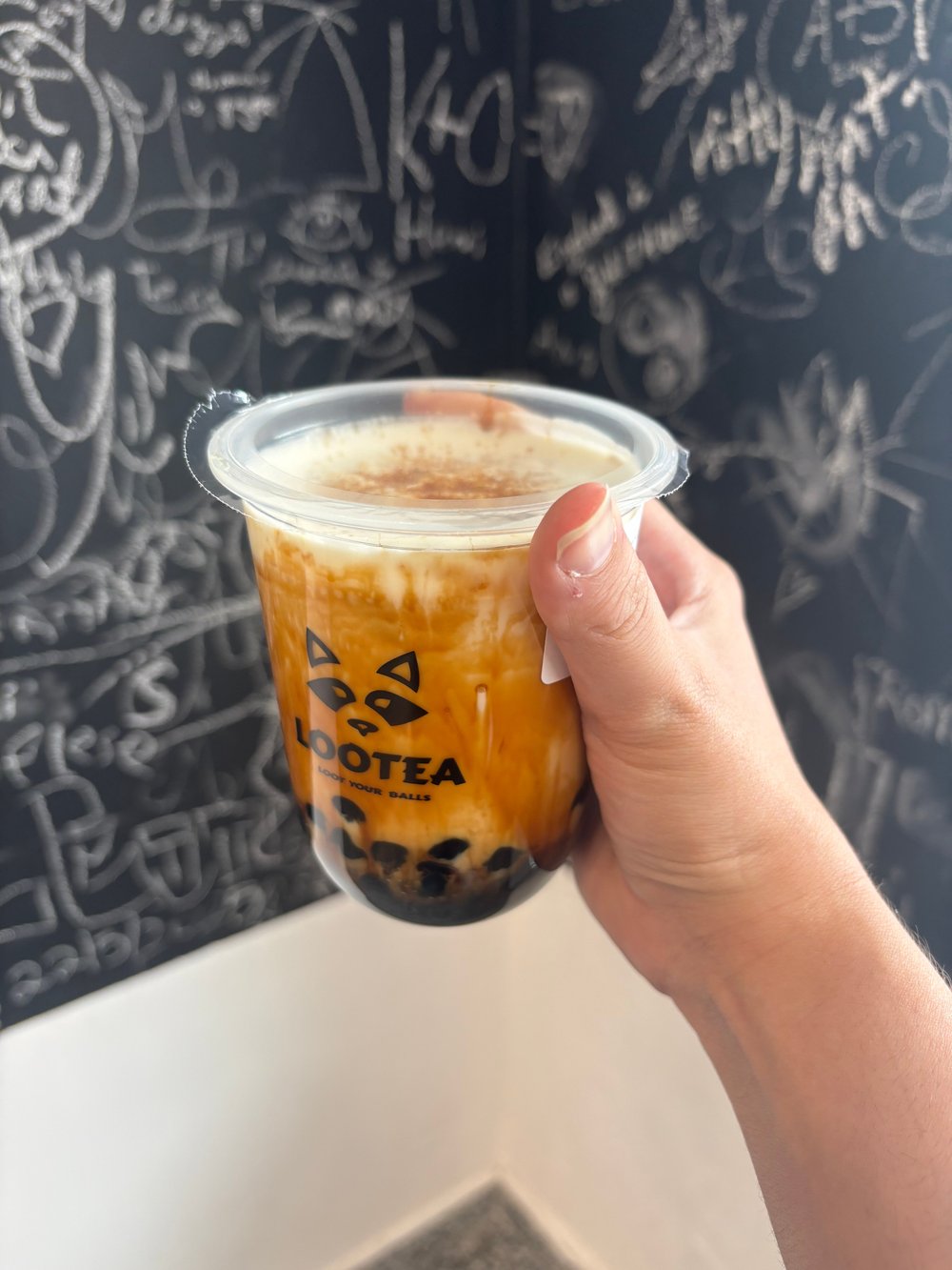 Ranya E’s photograph of a Brown Sugar drink in front of the handwritten messages at Lootea.